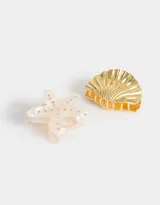 Set de dos broches para el pelo, uno dorado con forma de concha marina y otro blanco con forma de estrella de mar con incrustaciones de strass.