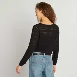 Chaqueta corta de ganchillo negra con escote redondo y lazos frontales.