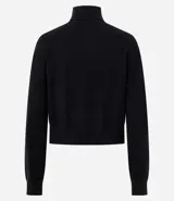 Blusa de punto color blanco, con cuello alto, manga larga y diseño liso.