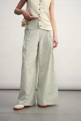 Pantalón palazzo a rayas verticales color beige y blanco, de tiro alto y corte amplio.