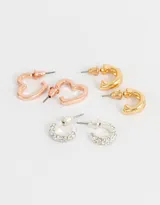 Set de tres pares de aros tipo argolla, uno plateado con strass, uno dorado y uno color oro rosa.