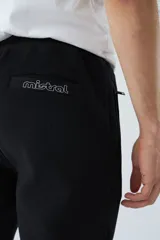 Pantalón de jogging negro de felpa con logo estampado y en goma, bolsillos con cierre, cierres en los tobillos, cintura ajustable y puños.