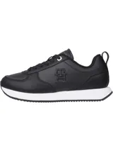 Zapatillas deportivas Tommy Hilfiger negras de cuero sintético, con cordones y suela blanca.
