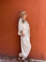 Pantalón de corte amplio color beige, con cintura elástica y lazo ajustable.