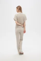 Pantalón gris de poliéster y lurex, holgado y de tiro alto, con textura acanalada.