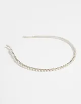 Vincha rígida metálica plateada con apliques de perlas y strass.