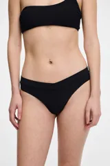 Colaless negra de lycra con textura acanalada y cintura elástica blanca.