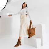 Botas cortas de cuero color marrón, con taco de madera forrado en cuero, elástico lateral y punta fina.