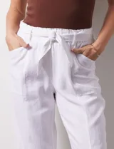 Pantalón blanco de lino con lazo en la cintura, corte recto y bolsillos laterales.