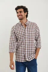 Camisa de cuadros en tonos marrón y blanco, con botones y mangas largas.