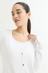 Cárdigan negro de tejido de punto fino con escote en V, cierre frontal con botones dorados y mangas largas con puños ajustados.