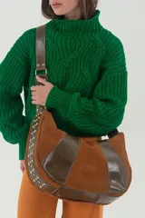 Cartera bandolera de cuero vacuno combinado: graneado en tono whisky, gamuza terracota y cuero liso chocolate. Tiene correa ajustable con herrajes metálicos y detalle de tachas.