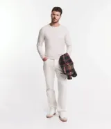 Suéter de punto color borgoña, con cuello redondo, sisas ligeramente desplazadas y bajo y puños acanalados.
