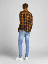 Jean de cinco bolsillos con diseño clásico, color azul denim. Cierre con botón. Corte slim fit con tiro bajo, rodilla ajustada y abertura de pierna ceñida.