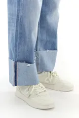 Pantalón de jean celeste de corte ancho con ruedo desflecado y dobladillo.