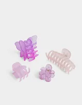 Set de cuatro broches para el pelo de plástico transparente en tonos lila y rosa, con forma de flor, mariposa y pinza.