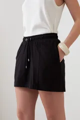 Short negro de corte recto con cintura elastizada y cordón ajustable. Presenta bolsillos laterales y detalle de costuras verticales en el frente.
