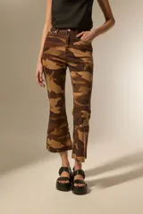 Pantalón de jean estampado camuflado en tonos marrones y beige, de corte flare, calce alto y ruedo deshilachado.