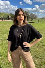 Remerón negro de algodón, de corte amplio y mangas cortas.