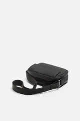 Bandolera negra de acabado engomado, con compartimento principal con cierre de cremallera y bolsillo interior de rejilla con cremallera. Bolsillo frontal con solapa y botones a presión. Asa de hombro ajustable y extraíble.