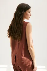 Top sin mangas confeccionado en mezcla de lino y algodón color marrón, con escote en V y pespuntes blancos decorativos en contraste.