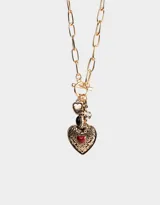 Collar corto dorado con cadena de eslabones grandes y cierre de gancho. Incluye dijes colgantes: corazón dorado liso, cuenta negra, cruz con strass y corazón dorado con corazón rojo en el centro.