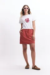 Minifalda color ladrillo de algodón, con cintura elastizada con lazo regulable y bolsillos laterales.