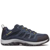 Zapatillas de senderismo Columbia modelo Crestwood Low en color azul marino. Presentan un empeine que combina gamuza y malla transpirable, con una mediasuela Techlite™ para mayor amortiguación y una suela de caucho Omni-Grip™ diseñada para tracción en diversos terrenos. Incluyen detalles en amarillo en los cordones y el logo de la marca.