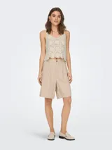 Top color crema de crochet con escote en V y tirantes anchos.