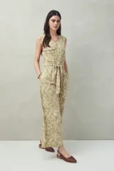 Mono enterito de algodón con rayas verticales color verde claro y beige, con cuello en V, sin mangas, con cierre frontal con botones y cinturón de lazo.