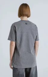 Remera gris melange de algodón premium, manga corta, cuello redondo y calce regular con recorte en la espalda.