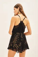 Minifalda negra con estampado de corazones dorados, cintura elastizada y volados en el ruedo.