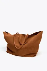 Bolso tipo maxi shopper color marrón de ante, con doble asa de hombro y bolsillo interior con cremallera.