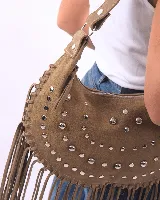 Bolso de hombro tipo boho, color bordó, confeccionado en gamuza con tachas plateadas y flecos largos. Tiene correa doble para usar al hombro o cruzado, forro interior y bolsillo interno.