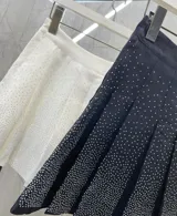 Minifalda tableada negra con short incorporado y strass plateados.
