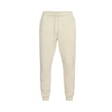 Pantalón de jogging color crema, de corte ajustado, con cintura elástica y cordón ajustable. Tiene bolsillos laterales y logo de Nike bordado en blanco en el muslo izquierdo.