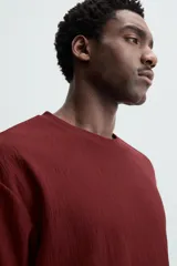 Camiseta de hombre color gris oscuro, de corte amplio, cuello redondo y manga corta.