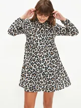 Vestido corto negro con cuello alto, mangas largas abullonadas y falda escalonada.