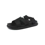 Sandalias negras con plataforma baja, tiras anchas y ajuste con velcro en el tobillo.