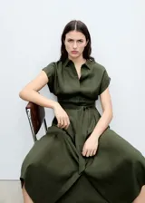 Vestido camisero midi color verde oliva, con cuello camisero, mangas cortas con dobladillo, cierre frontal con botones y cinturón de lazo.
