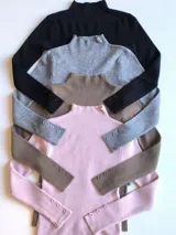 Pack de sweaters de punto acanalado con cuello alto y mangas largas con botones decorativos en los puños.