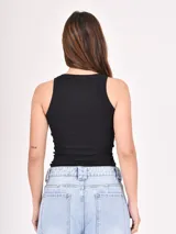 Musculosa negra ajustada al cuerpo, con cuello redondo y sisas anchas.