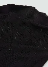 Medias de nailon negras con diseño de encaje floral.