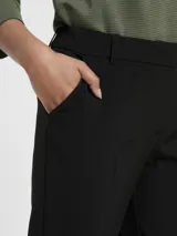 Pantalón de vestir negro de corte recto, tiro medio y trabillas para cinturón.