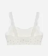 Soutien top blanco con estampado de flores pequeñas, breteles ajustables y detalle de encaje en el escote y los breteles.