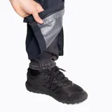 Pantalón impermeable Merrell Hardshell negro, con cintura elástica, diseño holgado, apertura lateral con cierre para acceder a los bolsillos del pantalón inferior, logo reflectante, ajuste en la parte inferior con cierre y botón snap, y bolsa para guardarlo.