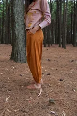 Pantalón tipo babucha color naranja, con cintura y puños elastizados, bolsillos delanteros y confeccionado en algodón.