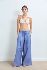 Pantalón ancho de algodón, color azul con rayas verticales blancas, tiro alto con cordón ajustable y pliegues frontales.