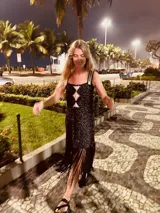 Vestido corto tejido en lurex con diseño geométrico en cuero en el frente, breteles de cuero intervenido a mano con tientos de cuero plateado y terminación en flecos.