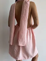 Vestido corto rosado con escote halter y falda acampanada.